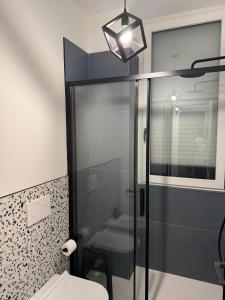 a bathroom with a glass shower and a toilet at Affittacamere38A in Pordenone
