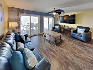 a living room with a couch and a table at Put-in-Bay Waterfront Condo #105 in Put-in-Bay