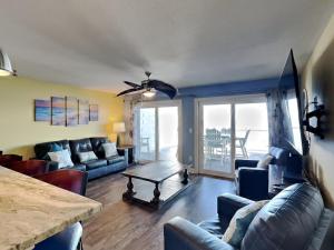 a living room with a couch and a table at Put-in-Bay Waterfront Condo #105 in Put-in-Bay