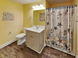 a bathroom with a sink and a shower curtain at Put-in-Bay Waterfront Condo #105 in Put-in-Bay +21 photos