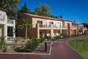 a row of apartment buildings with a driveway at SOWELL RESIDENCES Les Perles de Saint Tropez in Grimaud