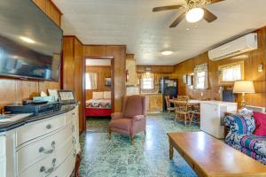 a kitchen and living room with a couch and a table at Walk to Greers Ferry Lake! Home with Dock Access in Greers Ferry