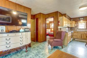 a kitchen with a white dresser and a bedroom at Walk to Greers Ferry Lake! Home with Dock Access in Greers Ferry