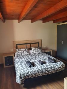 a bedroom with a bed with pillows on it at Casa Rural Baratza in La Revilla de Herrán