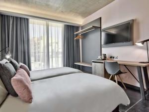 a hotel room with a large bed and a desk at Number 11 St Julian's Malta - Handwritten Collection in St Julian's +92 photos