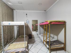 a room with three bunk beds in it at Hostel Nova Jerusalém in Cianorte