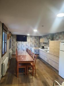 a kitchen with a wooden table and chairs in it at Casa Rural Baratza 