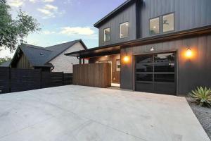 a house with a large driveway in front of it at South Lamar Luxe Creekside Retreat with POOL in Austin +28 photos
