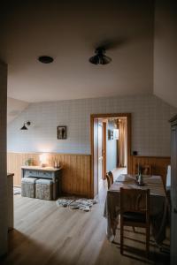 a living room with a table and a kitchen at eM Apartments Javorník in Vacov +42 photos