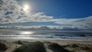 a view of a beach with the sun and the ocean at Cabañas San Jorge in Bella Vista