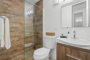 a bathroom with a toilet and a sink and a shower at Terrace Allows Pets Free Parking Otium in Beltran +16 photos