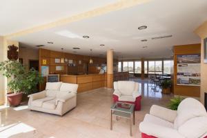 a lobby with two chairs and a table at My Rooms City Hotel Monte Blanco in Neaño