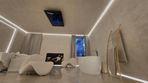 a living room with a white couch and chairs at DUNE at Spanish Steps Luxury Apartment-Suite in Rome +95 photos