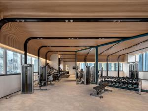 a gym with treadmills and exercise equipment in a building at Sofitel Shanghai North Bund in Shanghai