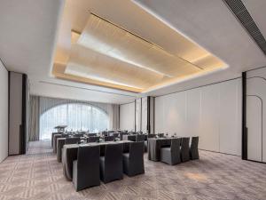a banquet hall with tables and chairs in a room at Sofitel Shanghai North Bund in Shanghai