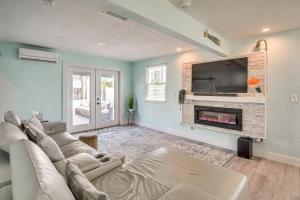 a living room with a couch and a fireplace at Walk to Ocean! Home with Large Yard in Ormond Beach in Ormond-by-the-Sea