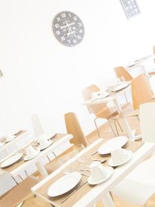 a dining room with white chairs and tables at Tavira Monte in Tavira
