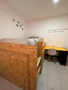 a bedroom with a bed and a desk with birds on the wall at Living Up in Puebla +18 photos