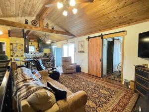 a large living room with a couch and a television at Montana Vista in Ponderosa Heights