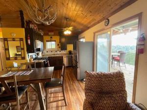 a kitchen and dining room with a table and chairs at Montana Vista in Ponderosa Heights