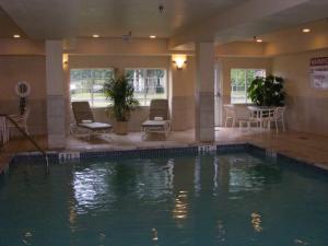 a large swimming pool in a hotel room with a pool at Candlewood Suites Windsor Locks by IHG in Windsor Locks