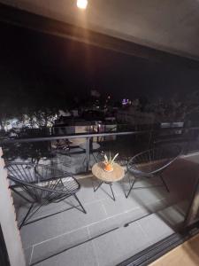 a table and chairs on a balcony at night at Dpto Arroyito in Rosario