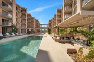 a swimming pool in the middle of a building at Bohari Las Arenas in Cabo San Lucas