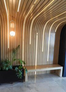 a wooden wall with a bench in a lobby at Seven Crown La Paz Malecon in La Paz