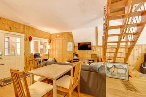 a living room with a couch and a table at Walk to Beach and Playground Charming Madison Cabin in Albany