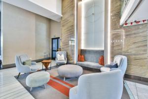 a waiting room with white chairs and tables at Menlyn apartment with ensuit Regency Hotel in Pretoria