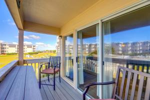 a balcony with two chairs and a view of the ocean at Eclectic Atlantic Beach Condo with Amenity Access! in Atlantic Beach