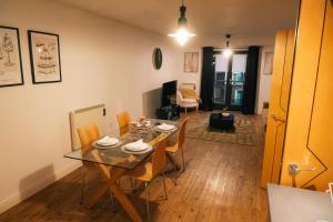 a dining room and living room with a table and chairs at Stylish Luxury Two Bed Jewellery Quarter in Birmingham