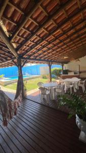 a wooden deck with tables and tables and chairs at Cantinho do Litoral Salvador in Salvador