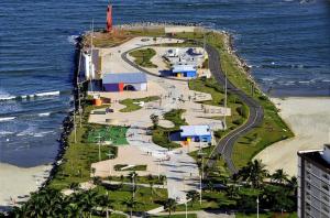 an island in the ocean next to the beach at Alto Mar Studio in São Vicente +13 photos