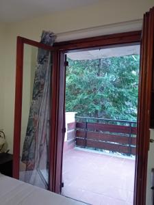 a sliding glass door with a view of a balcony at Luna Reale Roccaraso apt in Roccaraso