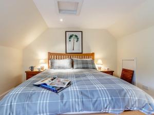 a bedroom with a bed with a newspaper on it at 5 Bed in Blacklunans CA409 in Cray