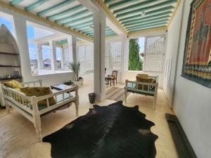 a living room with a couch and a table at Baytulkher in Lamu