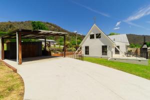 a driveway with a pavilion in front of a house at The Church House Luxe High Country Stay in Mount Beauty