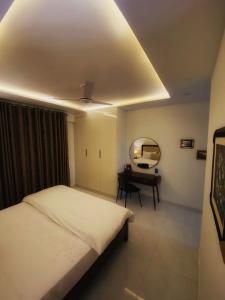 une chambre avec un lit, un miroir et un bureau dans l'établissement Stoners zone, à Lahore