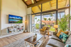 a living room with a couch and a table at Perch - Luana Kai Loft C308 in Kihei