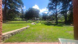 a view of a yard with grass and trees at La Quebradita-Tafi del Valle in Tafí del Valle +12 photos