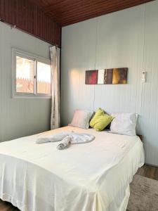 a bedroom with a large white bed in a room at Cozy Studio Apartment Maculusso, Luanda in Luanda