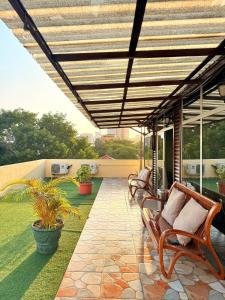 een terras met banken en luifel op een huis bij Cozy Studio Apartment Maculusso, Luanda in Luanda