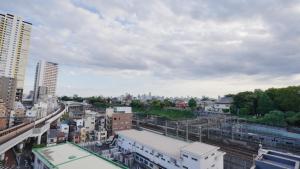 a view of a city with a train station and buildings at LIO HOTEL Tokyo Nippori in Tokyo