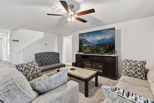 a living room with two couches and a flat screen tv at Cute and cozy Homes in Buckeye in Buckeye