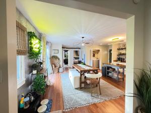 a living room with a table and a dining room at Vibing Hudson Retreat Pet-Friendly w Hot Tub in Hudson