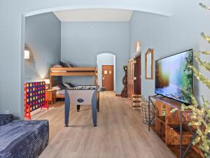 a room with a bed and a table and a tv at Indoor Water Park - Game Rm - Mins to Downtown - Jacuzzi in Wisconsin Dells