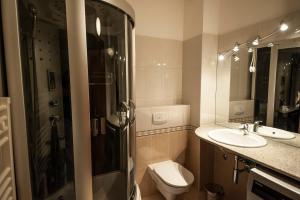 a bathroom with a toilet and a sink and a shower at Apartment May in Mali Lošinj