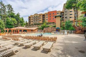 a group of lounge chairs and a swimming pool at Indoor Water Park - Game Rm - Mins to Downtown - Jacuzzi in Wisconsin Dells