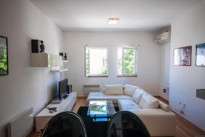 a living room with a couch and a table at Apartment May in Mali Lošinj